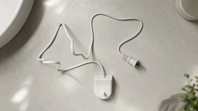 Aftermarket Philips Sonicare replacement charger base with full cord and two-prong US plug on a bathroom counter